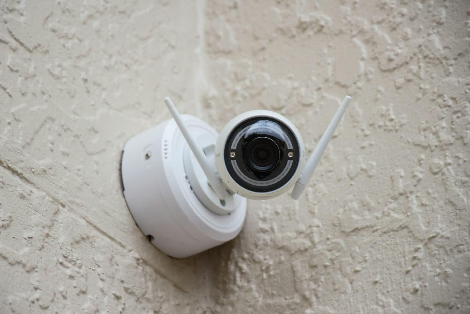 Wireless security camera mounted on the outside wall of a home